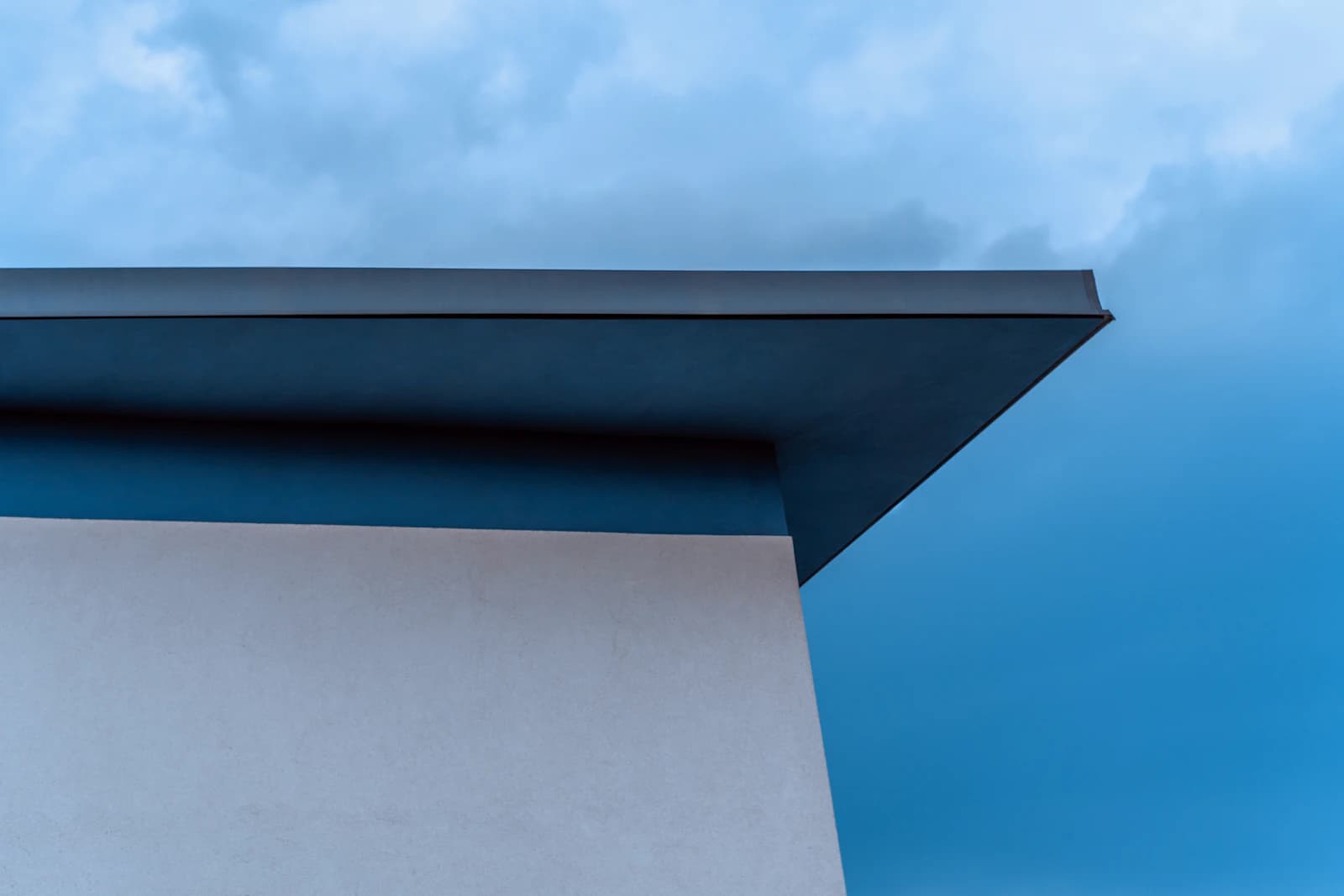 Modern huis met plat dak en zicht op de dakbedekking en hemelwaterafvoer